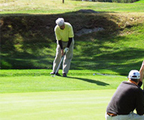 Gene Cufone chips on the 18th green at Valley Country Club.